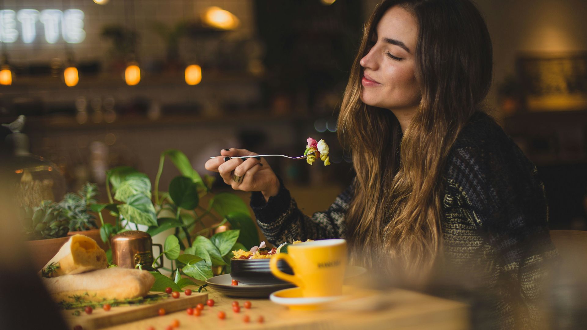 woman holding fork in front table