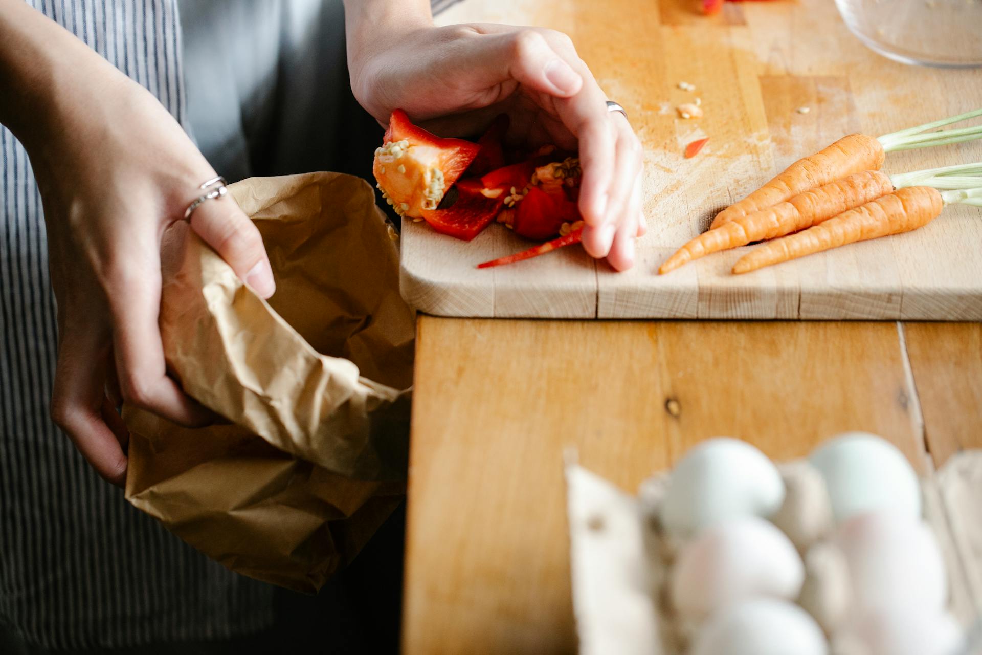 Woman cleaning cutting board in kitchen