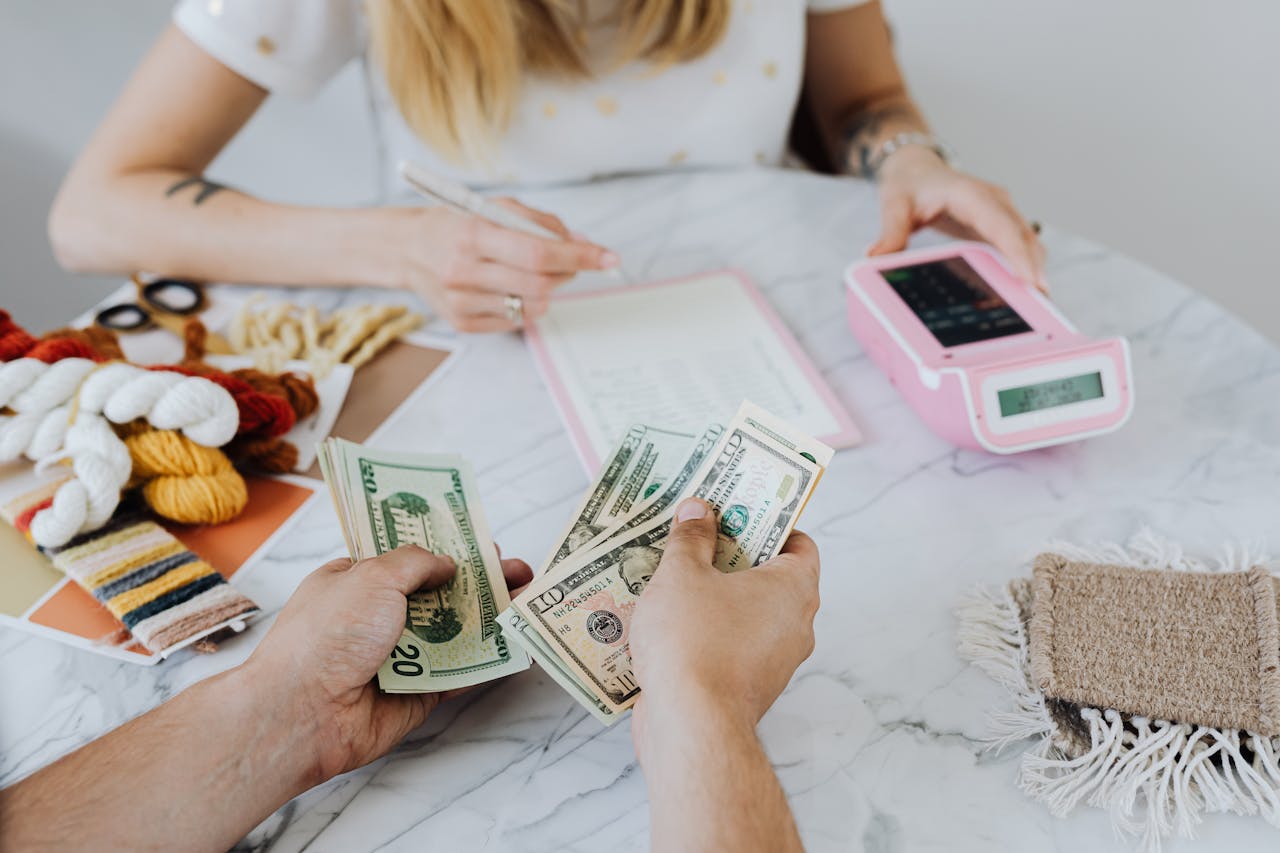 Two people Counting Dollar Bills