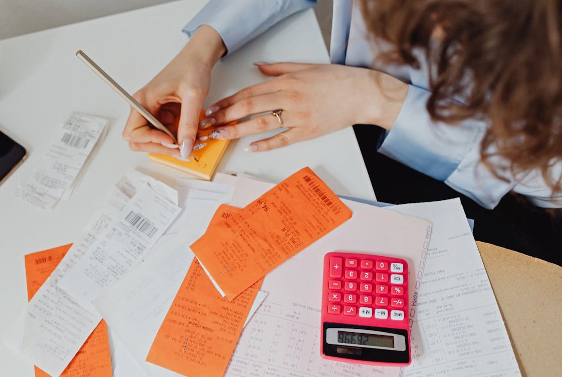 Person Writing on a Sticky Note
