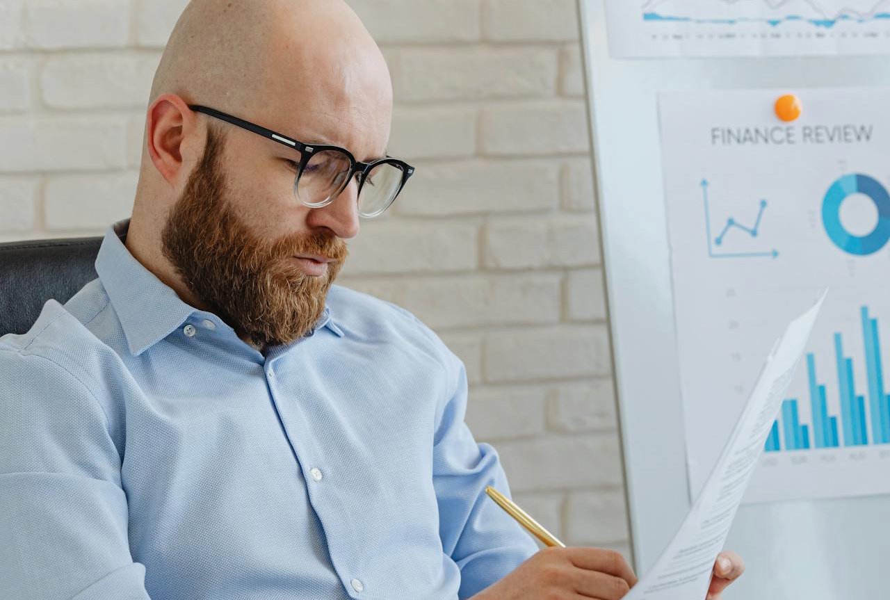 A Man in Corporate Attire Writing