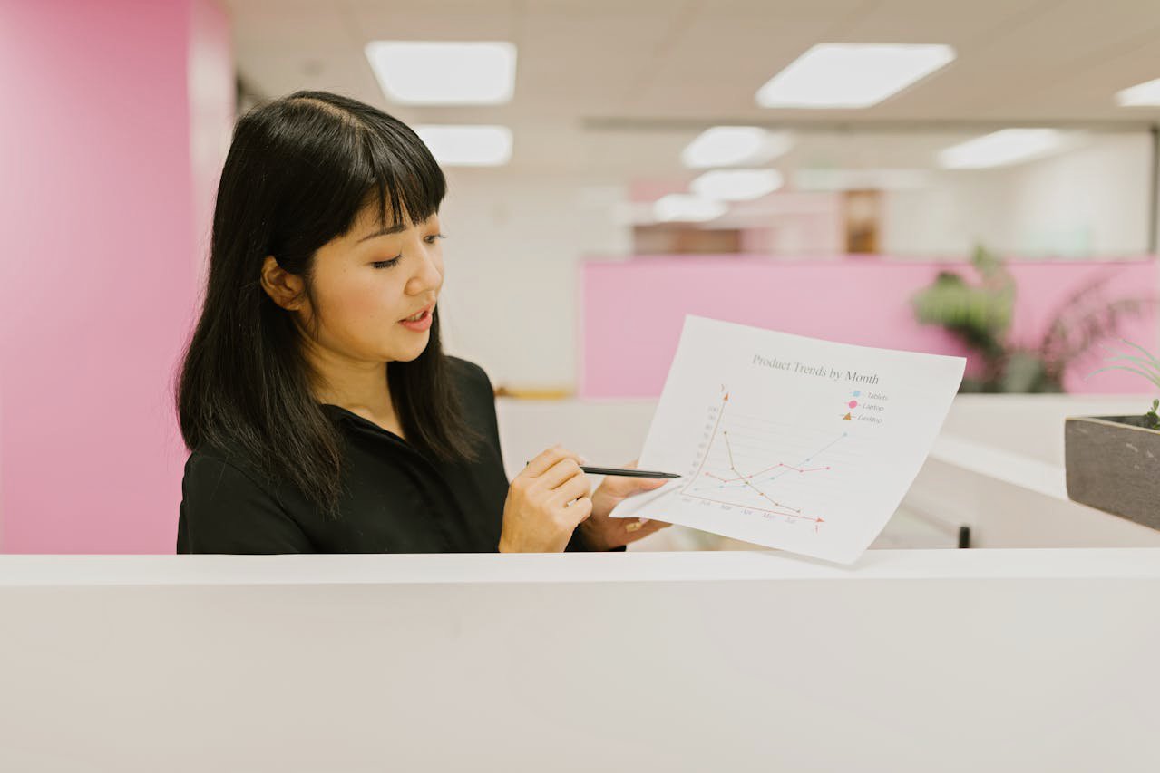 A Woman in the Office Holding a Document