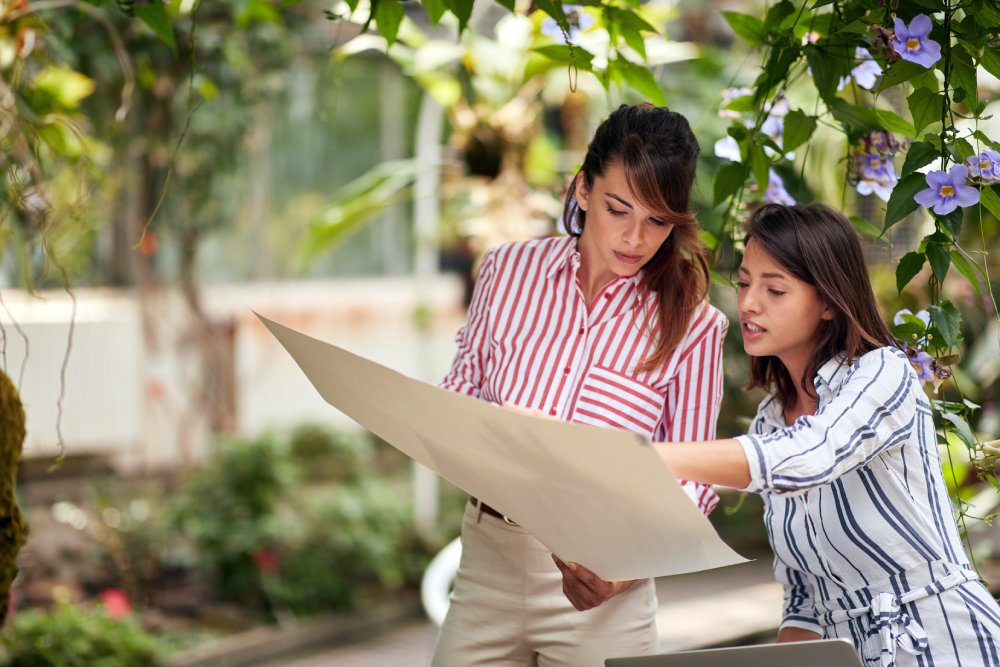 Portrait Photo of Two Landscape architects designing a garden