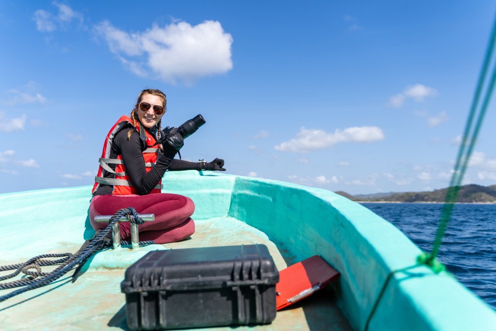 Portrait Photo of Female marine biologist working sitting on a boat