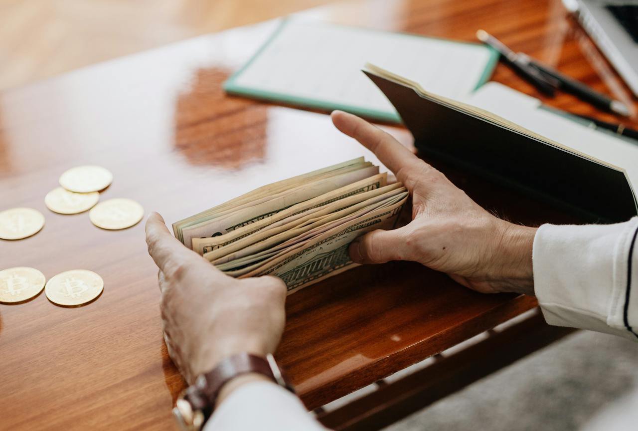 A Person in White Long Sleeve Shirt Holding Bank Notes