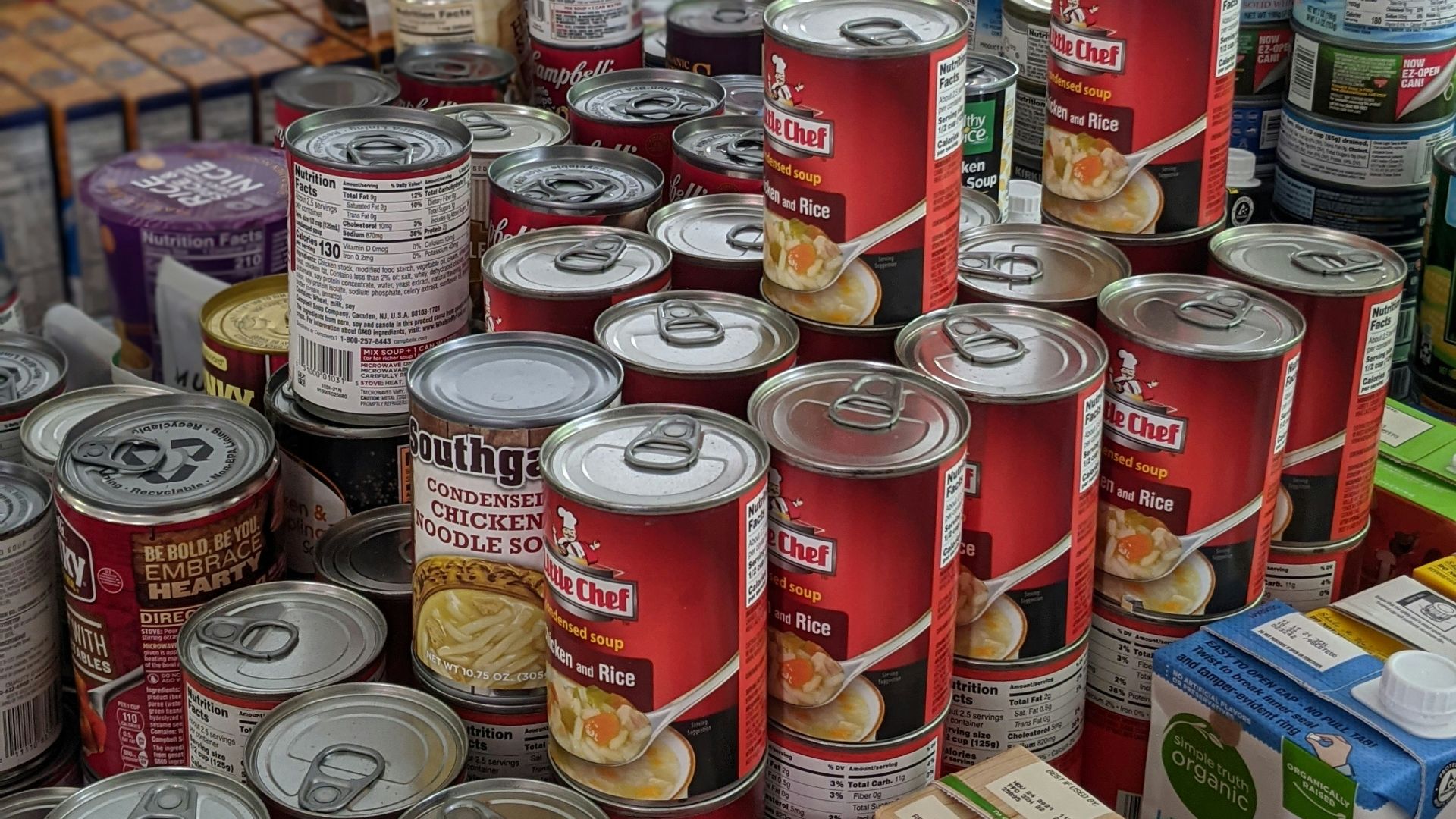 red and white labeled cans