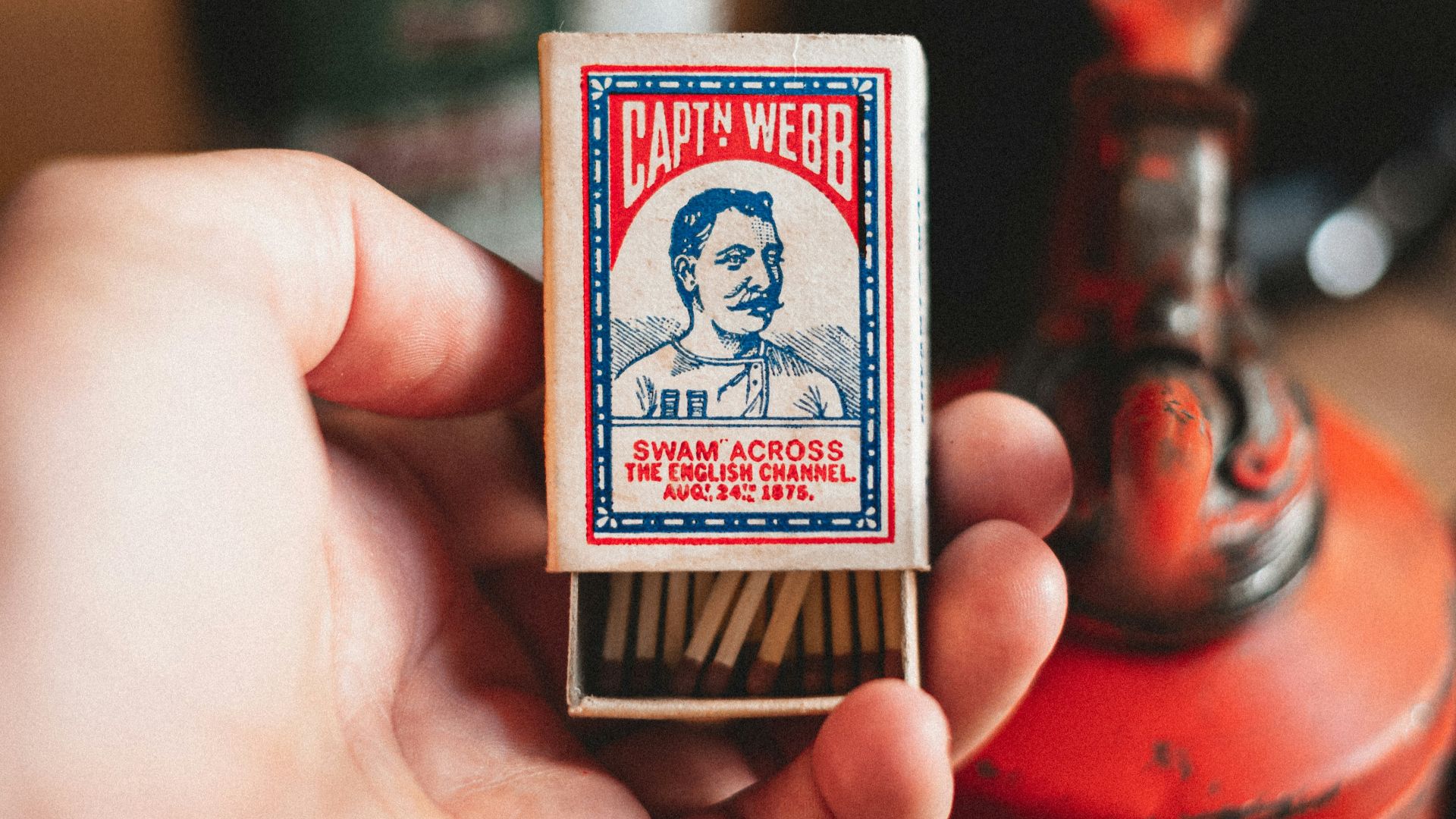 person holding red and white jack of diamonds playing card