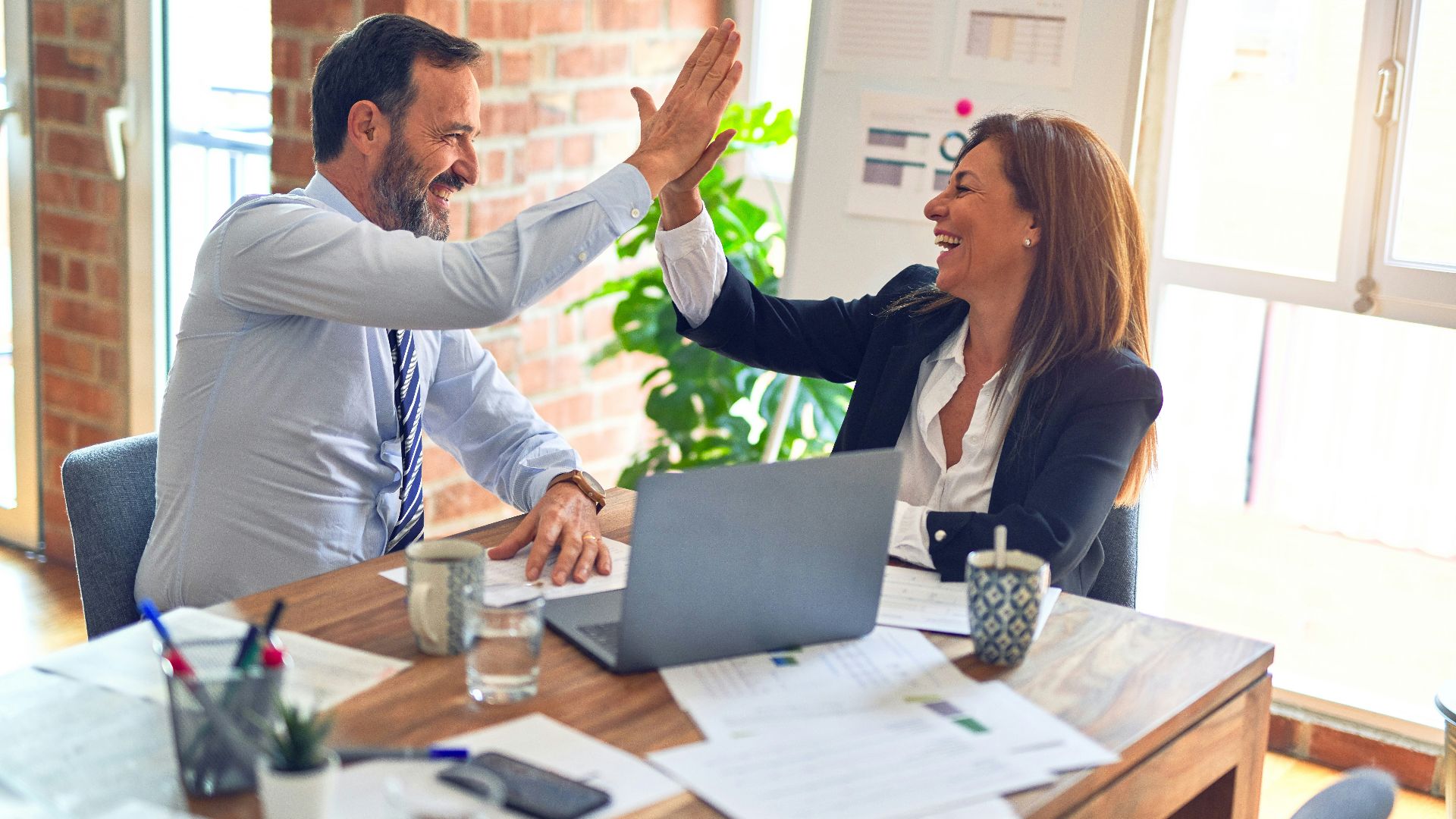 man in white dress shirt sitting beside woman in black long sleeve shirt
