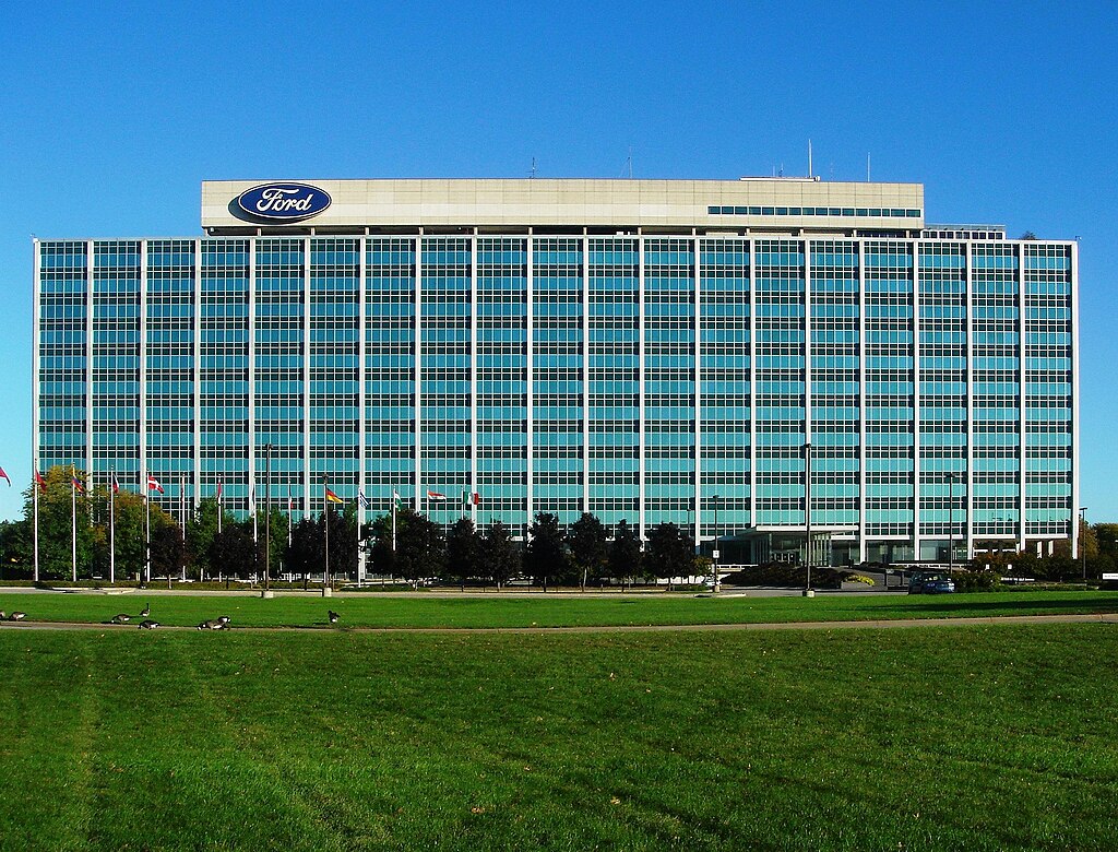 The image shows the corporate headquarters or office building of Ford Motor Company