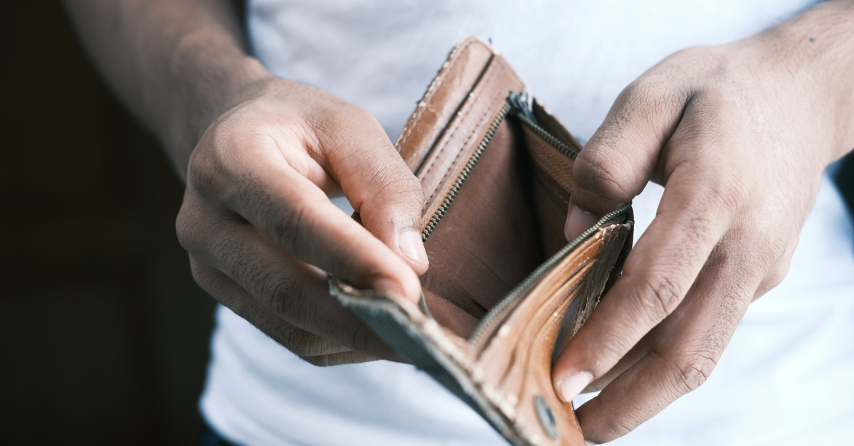 person holding brown leather bifold wallet