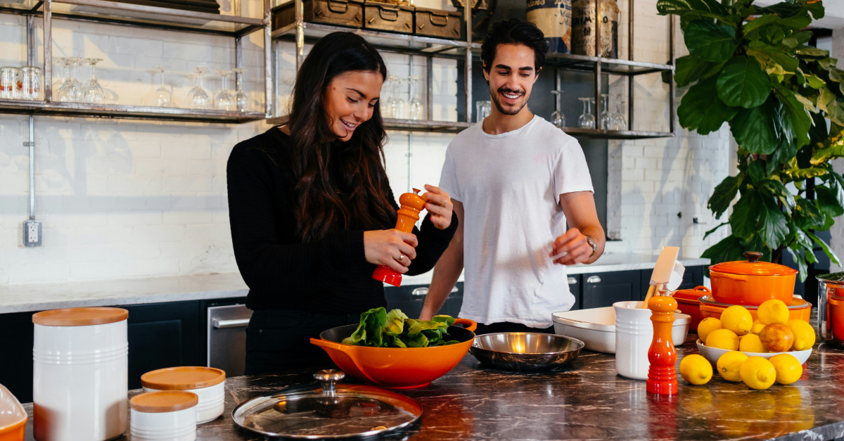 man and woman standing in front of table
