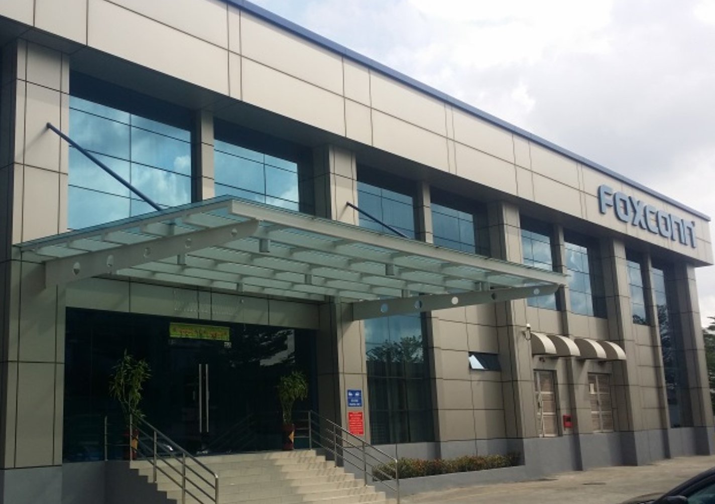 The image shows the corporate headquarters or office building of Foxconn Company