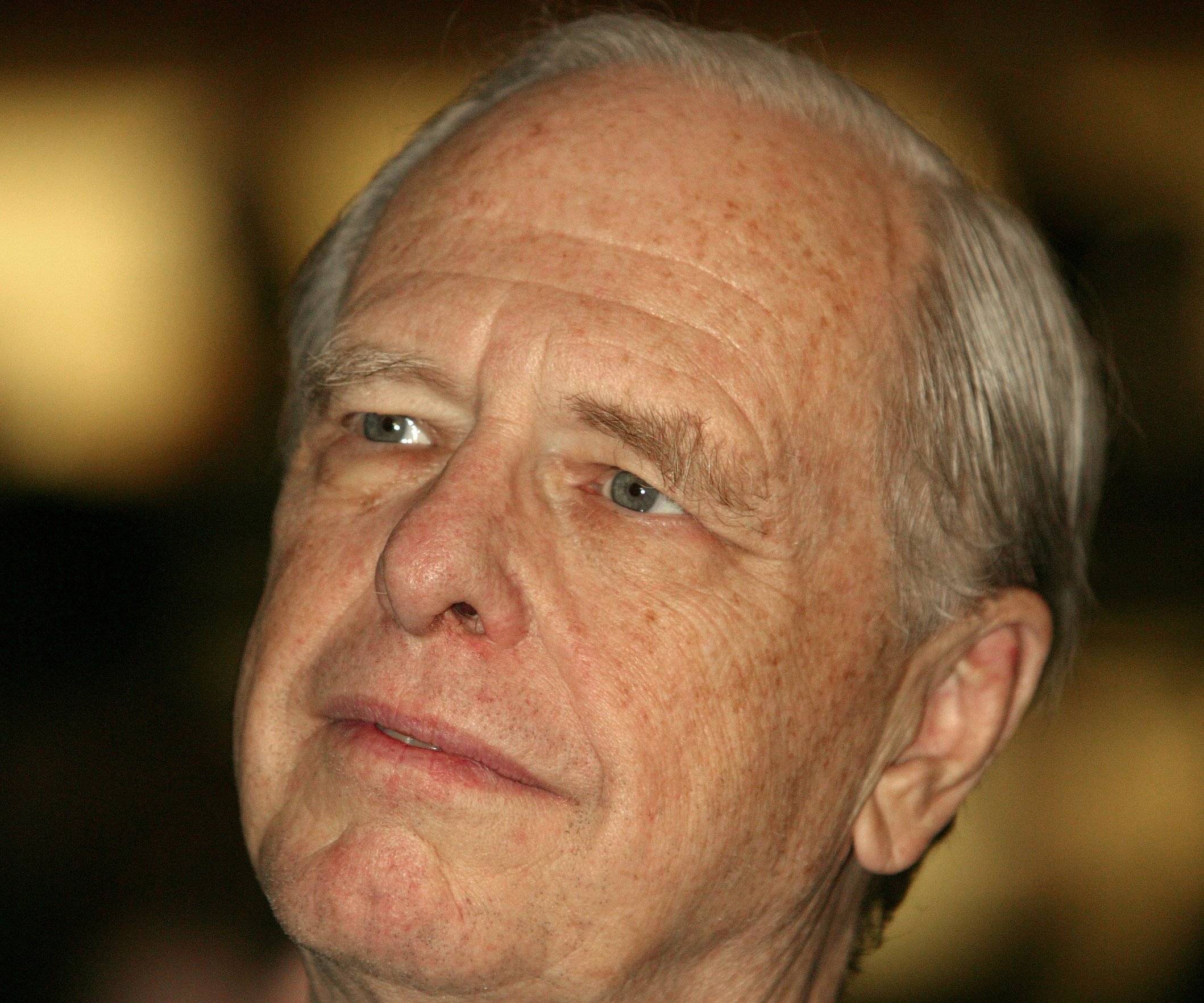 Edward (Ned) C. Johnson III listens as President George W. Bush speaks to company employees