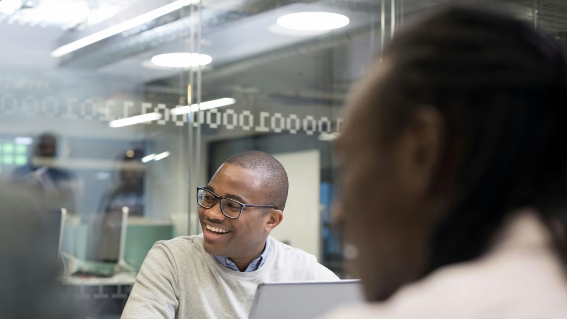a man sitting at a desk with a laptop in front of him
