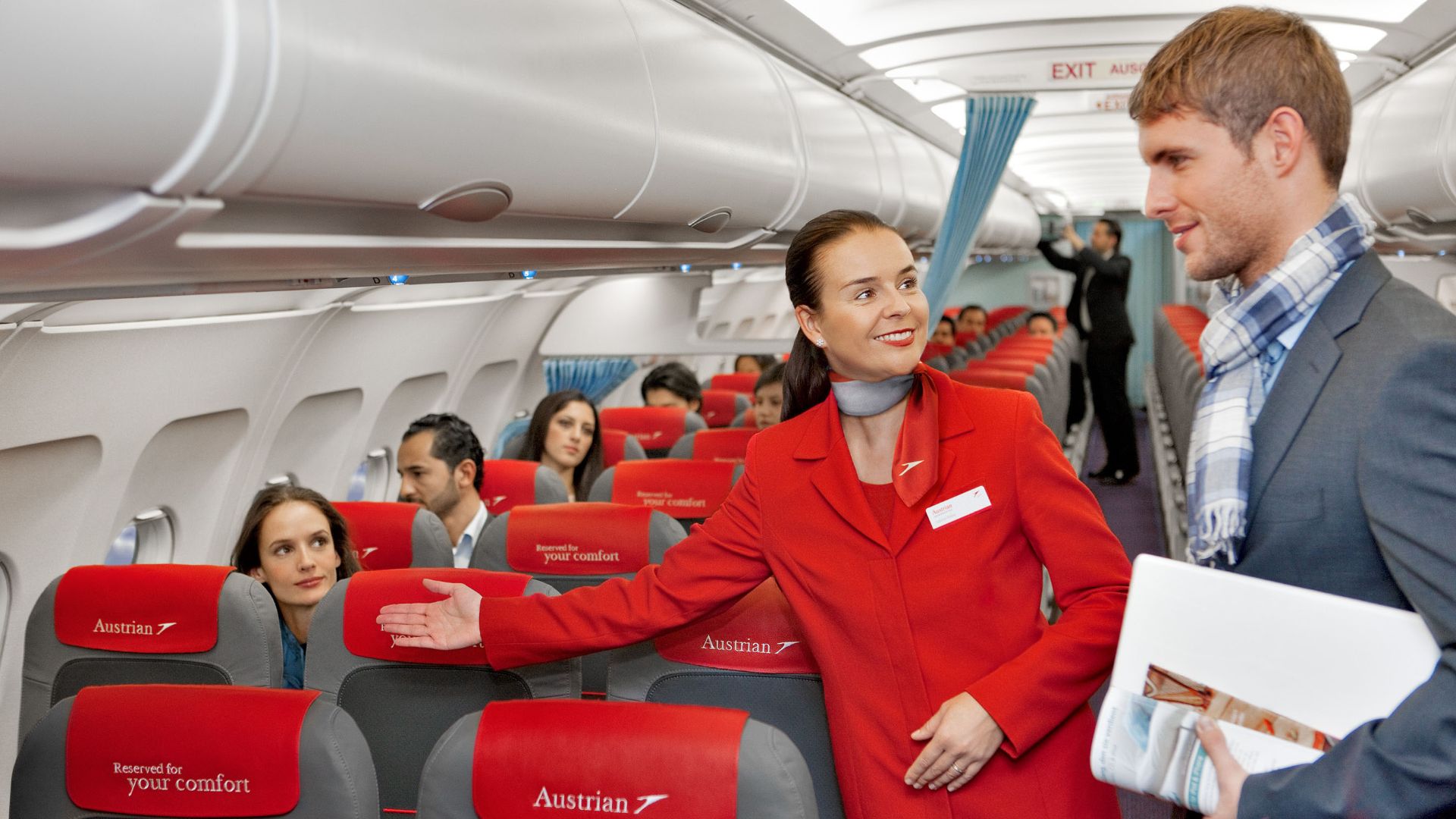 File:Austrian Airlines flight attendant and passenger.jpg