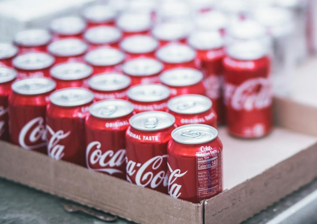 Selective Focus Photography of Red Coca-cola Can Lot on Box