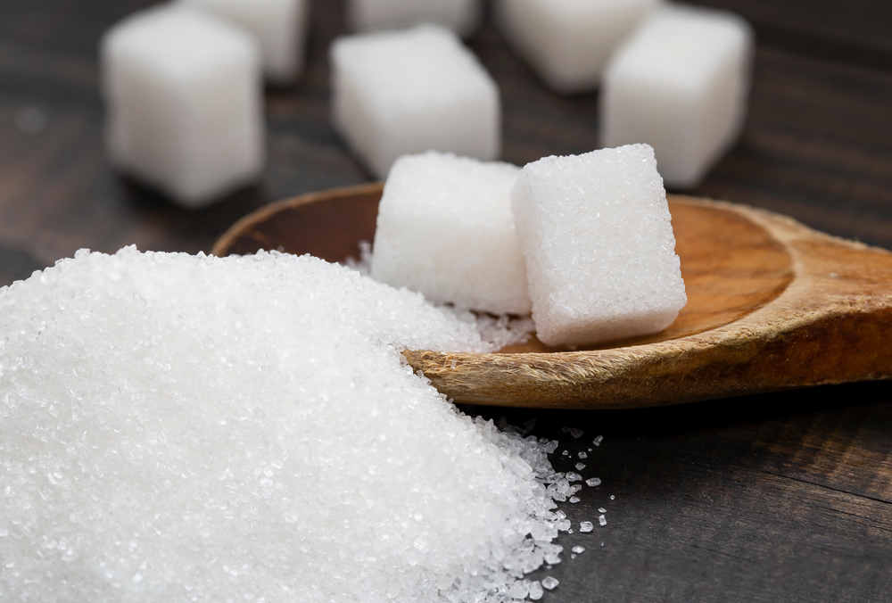 White, crystalline granulated sugar and white cube sugar.