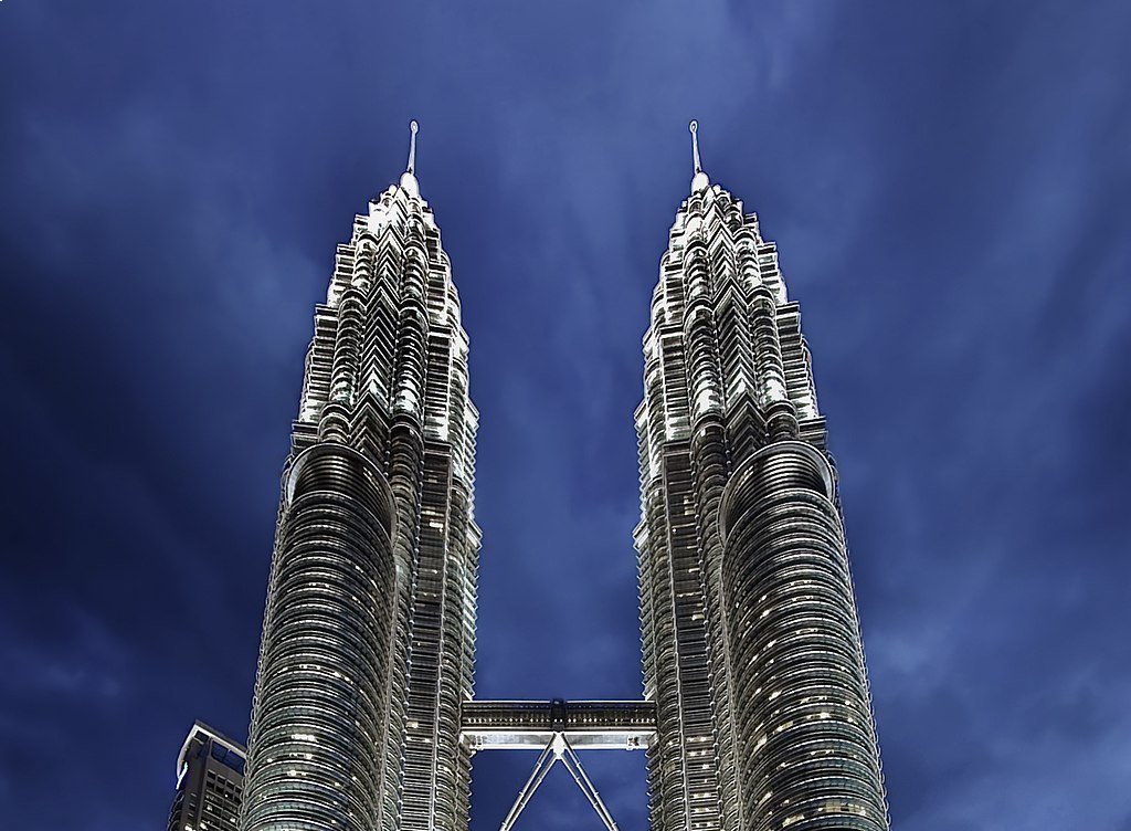 The image shows the corporate headquarters or office building of Petronas Company