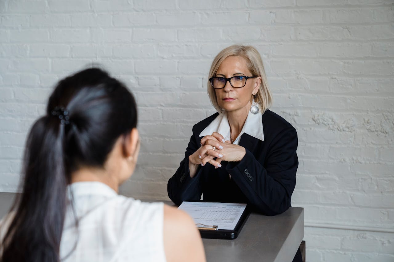 Blonde Woman Sitting With Her Hands Together