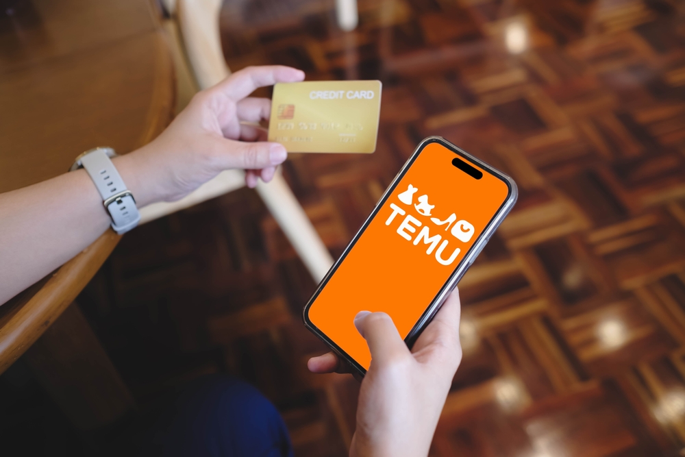 A woman using credit card and open Temu