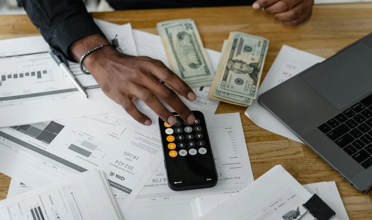 Hand of a Person Using a Calculator