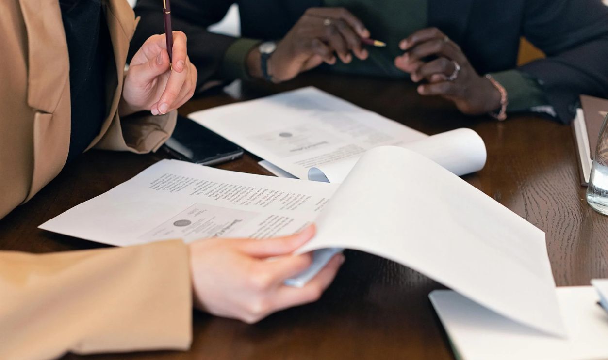 A Close-Up Shot of People Reviewing Documents