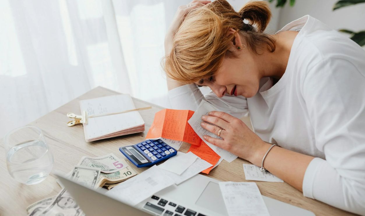 Woman Sitting at the Desk with Receipts