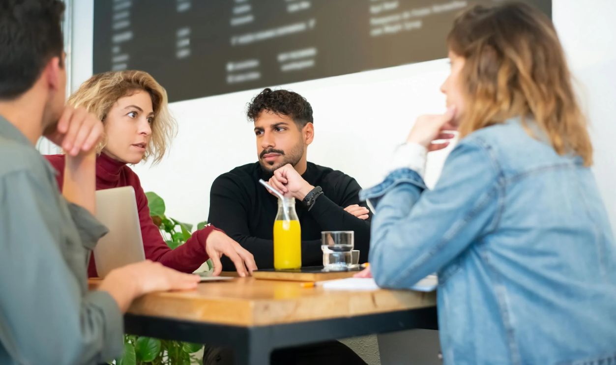 People Having a Conversation in a Cafe