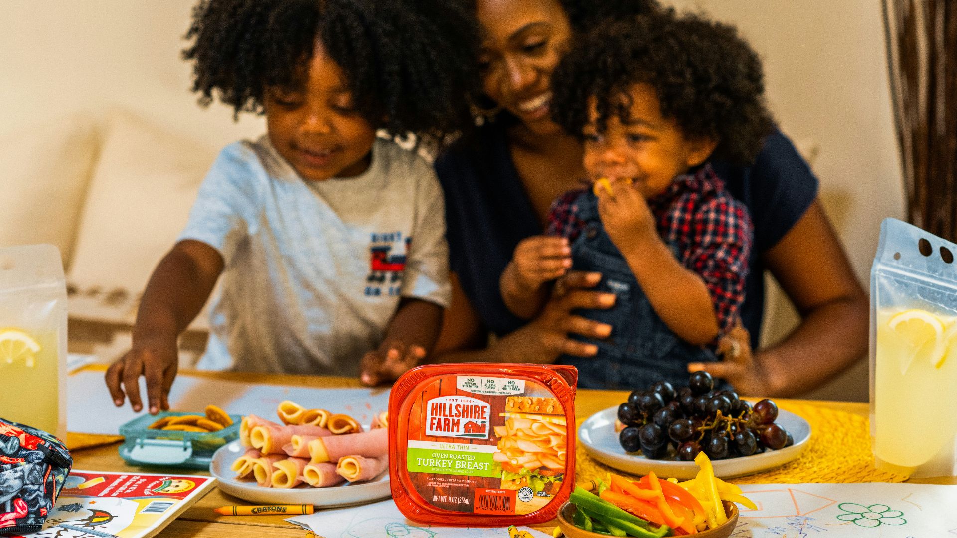 man in gray crew neck t-shirt sitting beside woman in black and pink checkered dress