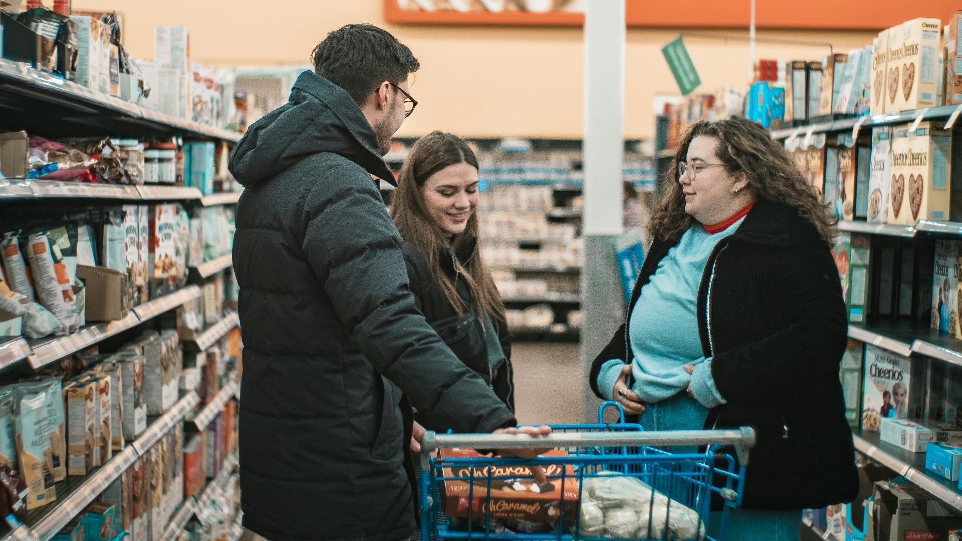two men and man standing beside push cart