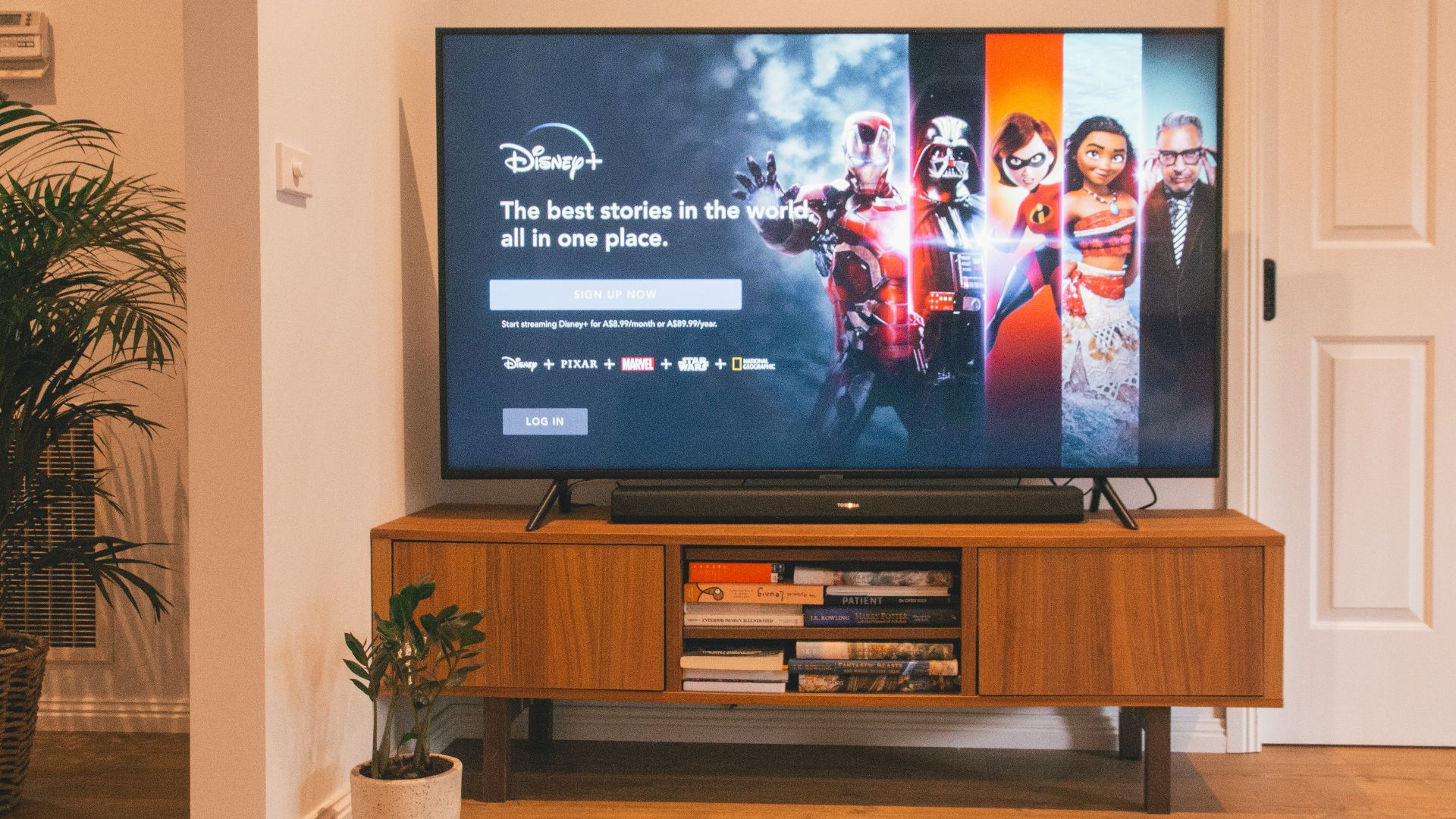 black flat screen tv turned on on brown wooden tv rack