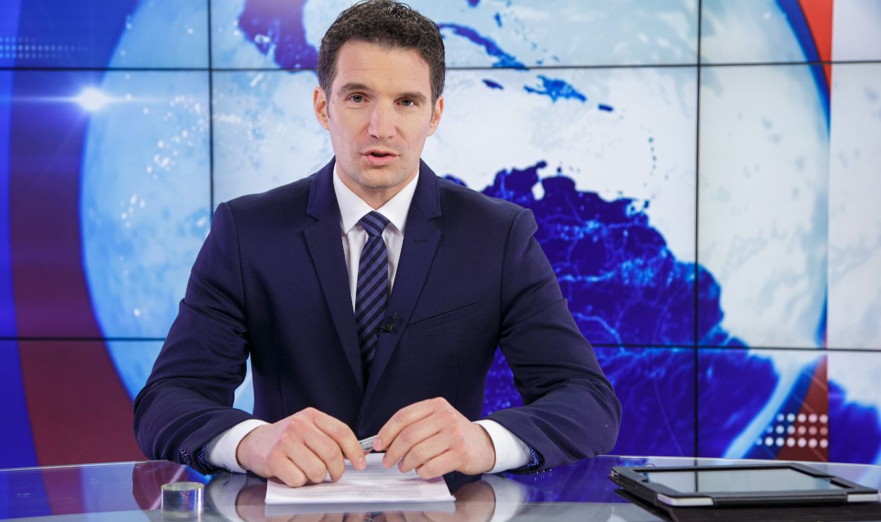 Man sitting in news studio. Today's news story.