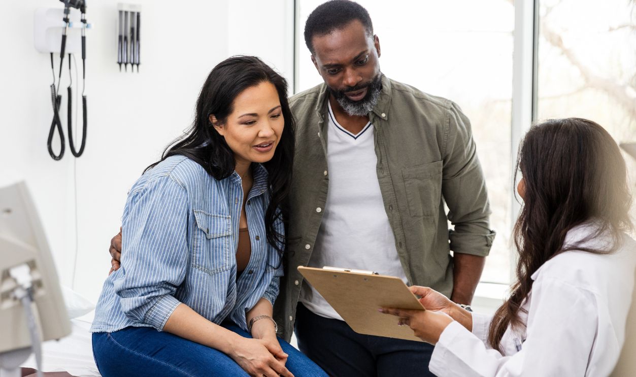 The unrecognizable female doctor shows the couple the medical test results that they obtained recently from her other provider.