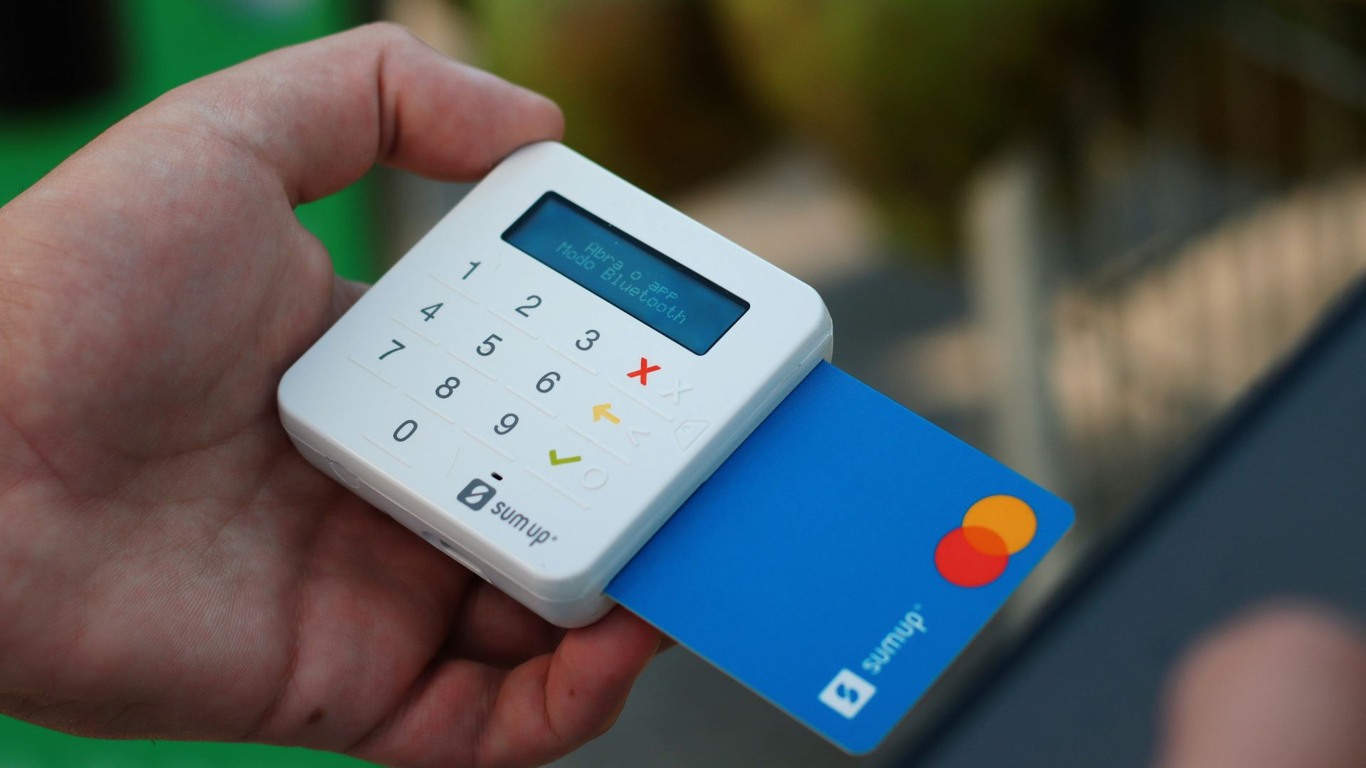 a person holding a credit card and a cell phone