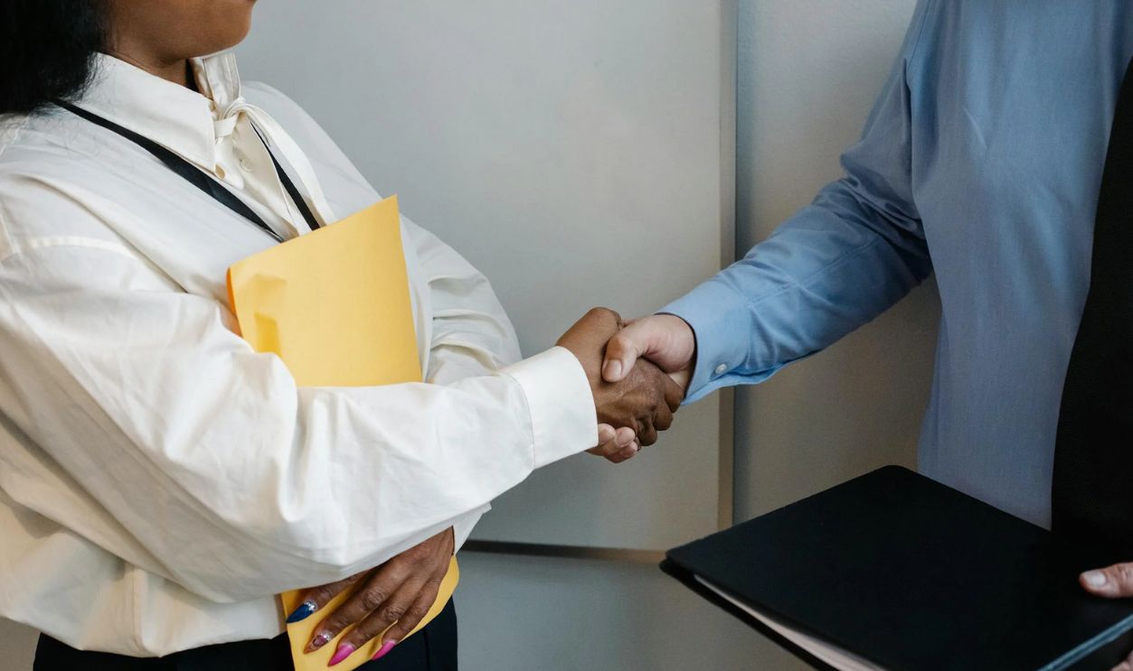 Diverse coworkers shaking hands after meeting
