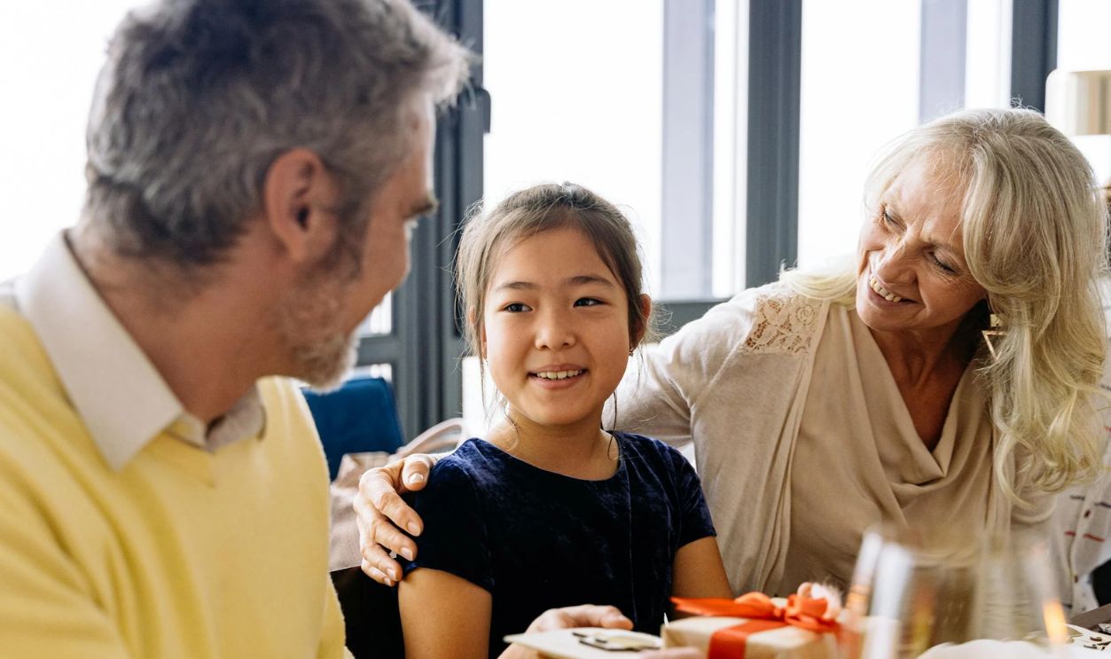 A Girl Sitting Between Elderly Couple
