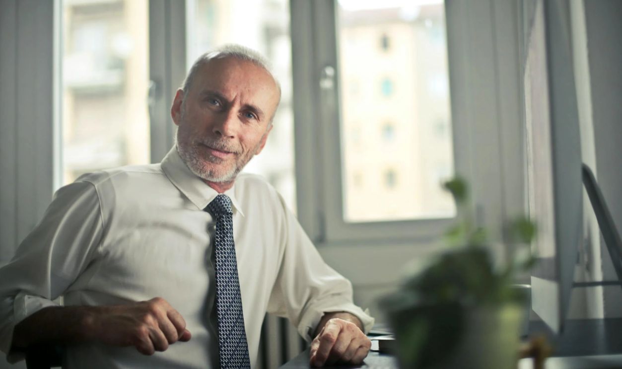 Man Sitting on Chair Beside Table
