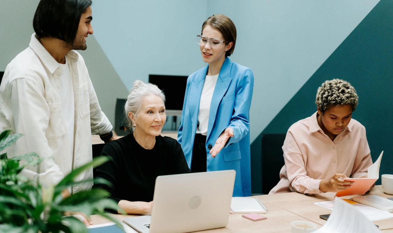 Group of People Sitting on Chair in Front of Table