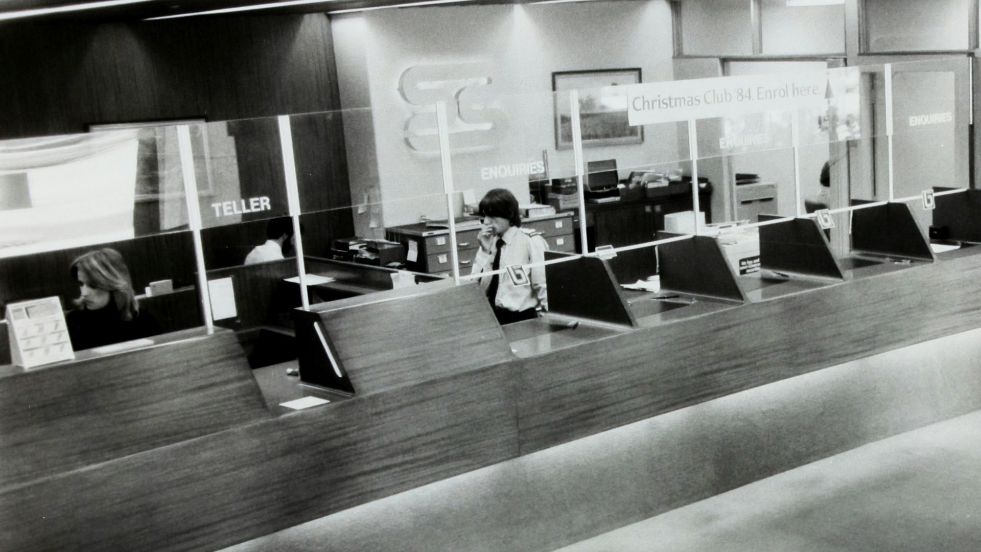 grayscale photo of man holding paper