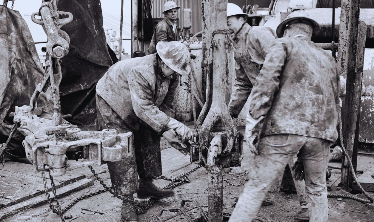 Gettyimages - 1248925183, Offshore Oil Drill In Gulf Of Mexico 1960s Four Men Roughnecks Drillers Wearing Safety Hard Hats And Canvas Clothing Working On Offshore Oil Drill In Gulf Of Mexico