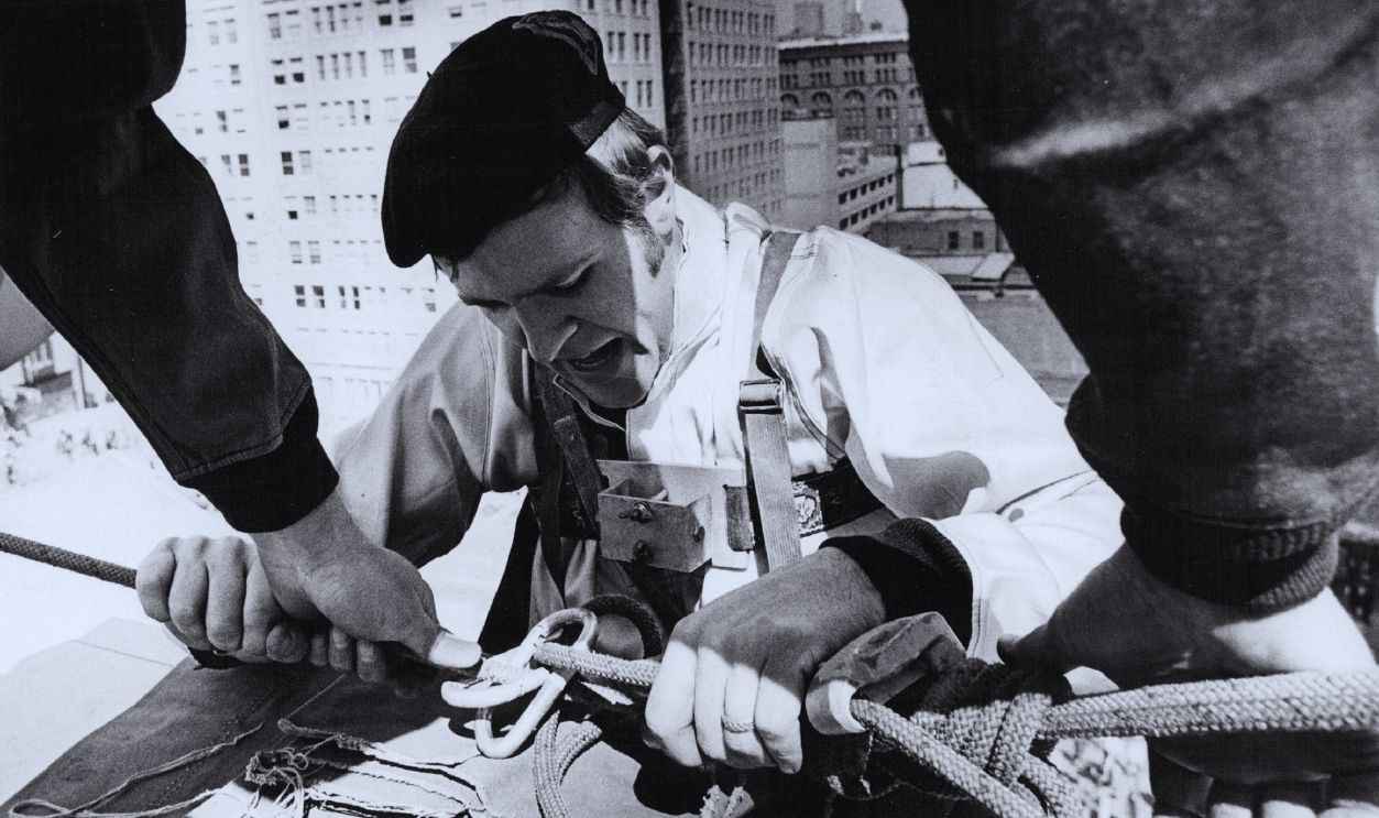 Gettyimages - 836927410, Denver Post Archives MAR 20 1973, MAR 21 1973 Petzoldt Staffers Scale 'Mountain' Here Haven Holsapple Completes Climb To Top Of Building And Is Helped Over Edge By Rick Pallister Holsapple formerly taught cave exploring in Tennessee for Paul Petzoldt's National Outdoor Leadership School. Credit: Denver Post