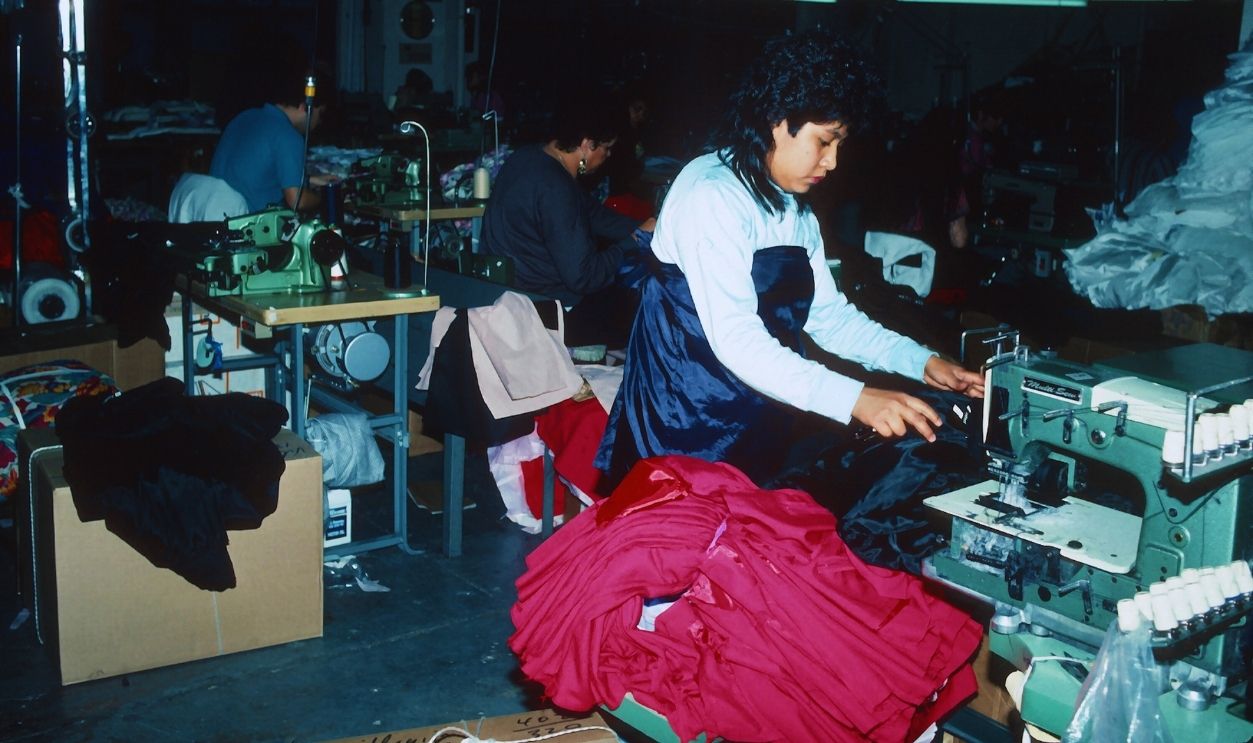 Gettyimages - 182993244, Sweatshop In Queens QUEENS, NEW YORK - MARCH 25: Immigrant workers at a sweatshop in Queens, New York are photographed March 25, 1990. Employees work long hours for very little pay and are exposed to unsafe conditions. Child labor laws are violated as well as buiding codes, such as fire hazards, ignored.