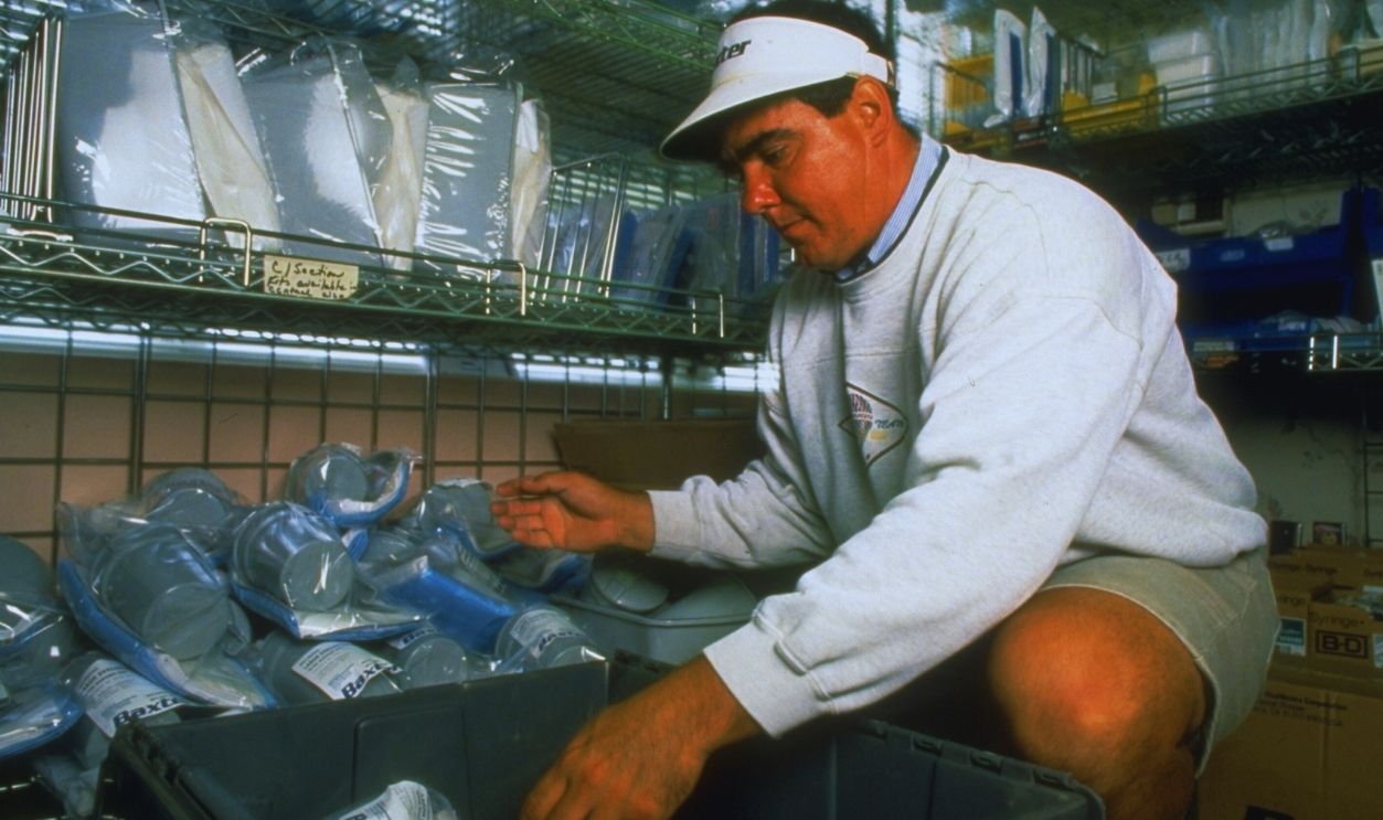 Gettyimages - 50371763, Baxter Intl. employee stocking medical s Baxter Intl. employee stocking medical supplies directly on floor of Seton Medical Center, re improving service.