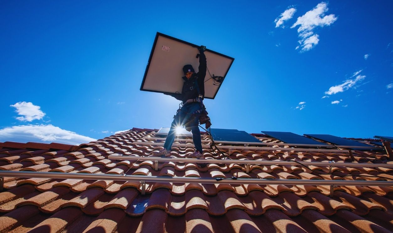 Gettyimages - 1278663143, Employees of Sunrun, nation's largest rooftop solar installer lift panels onto a roof