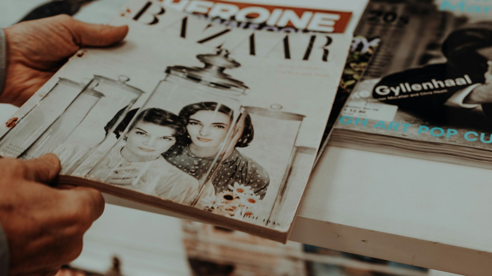 a person holding a magazine in their hand