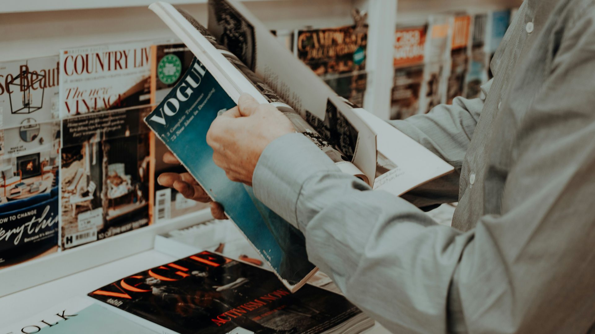 a man reading a book in a bookstore