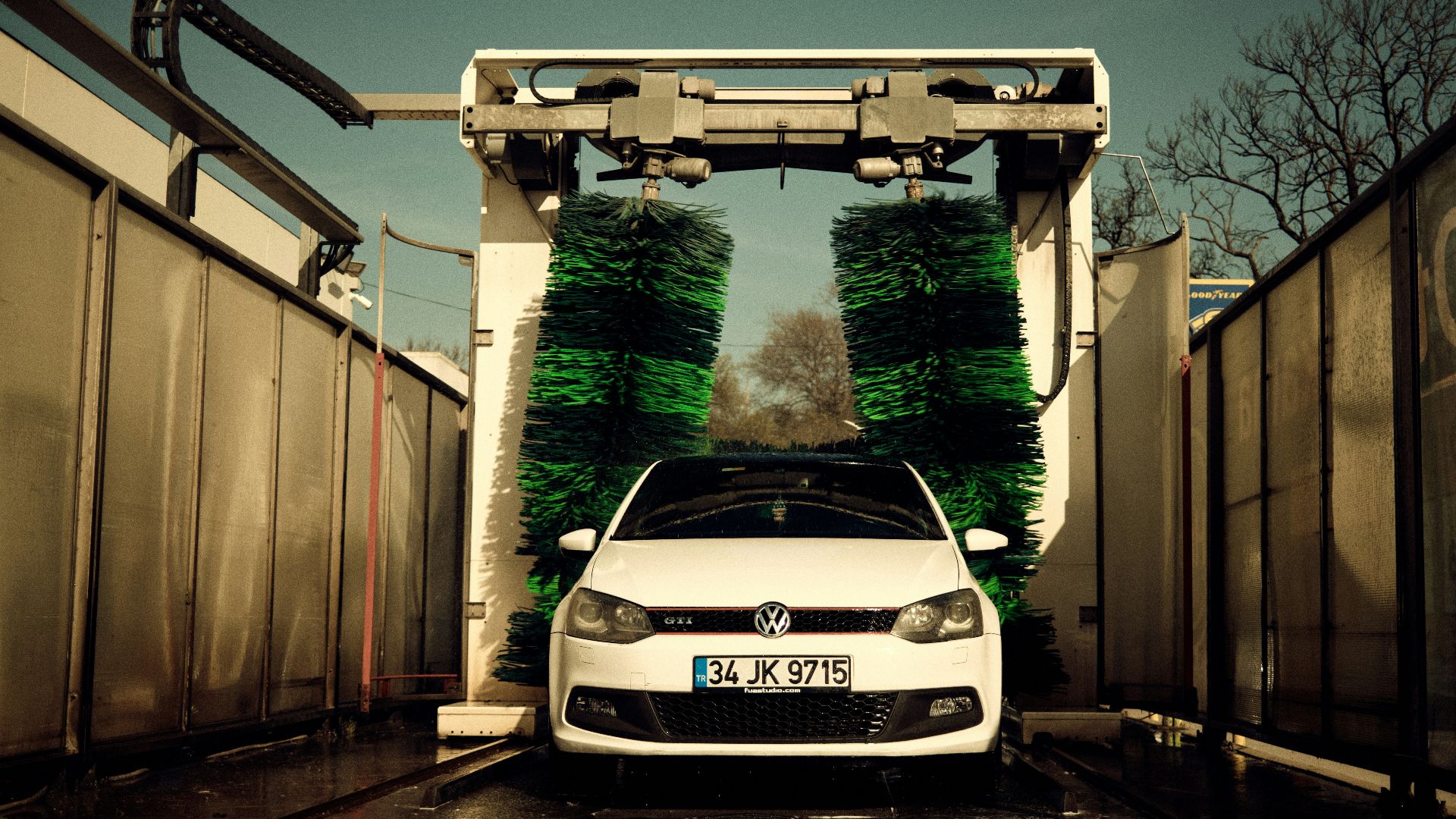 a white car parked in front of a gate
