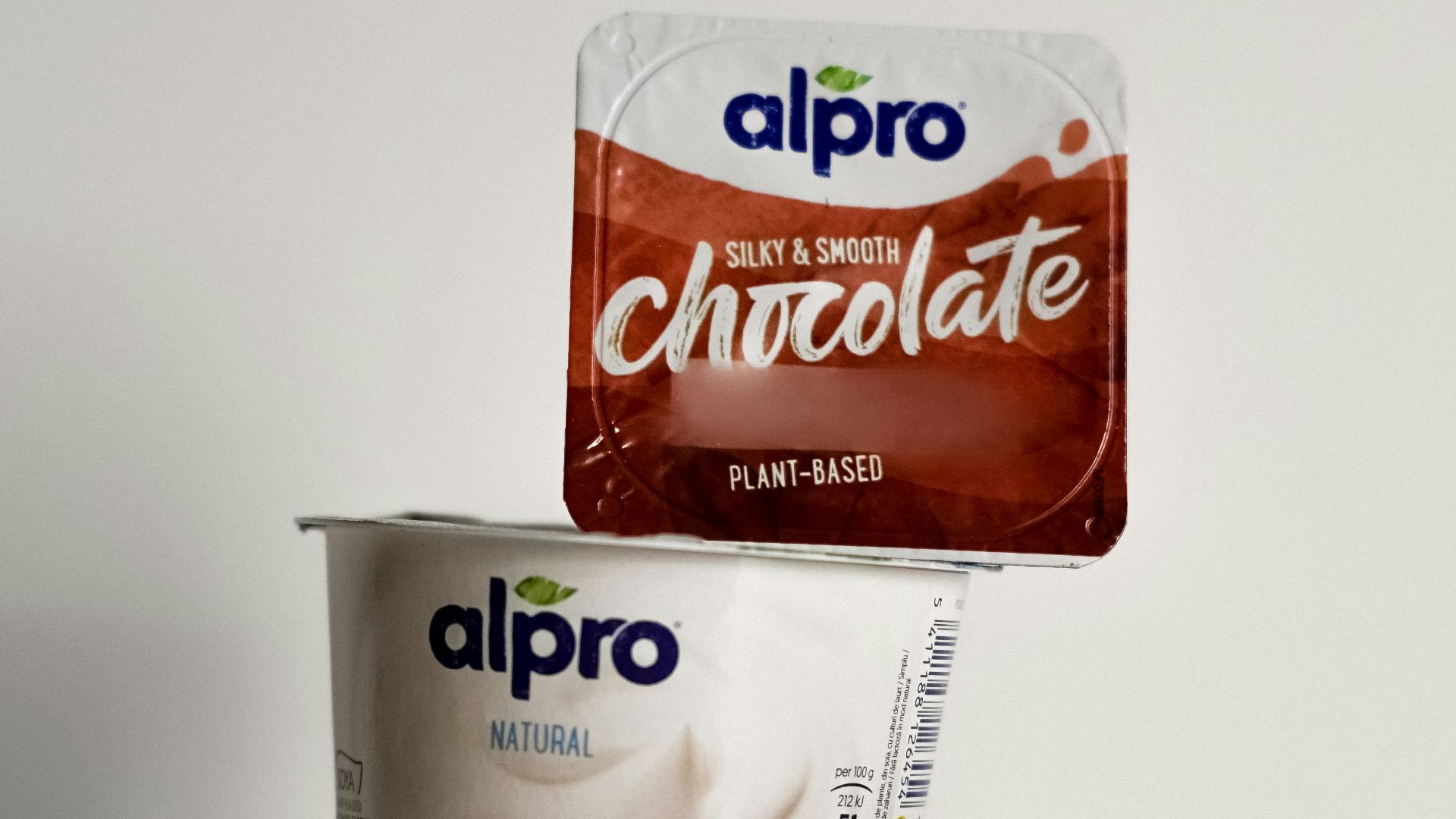 two cups of ice cream and a bag of chocolate