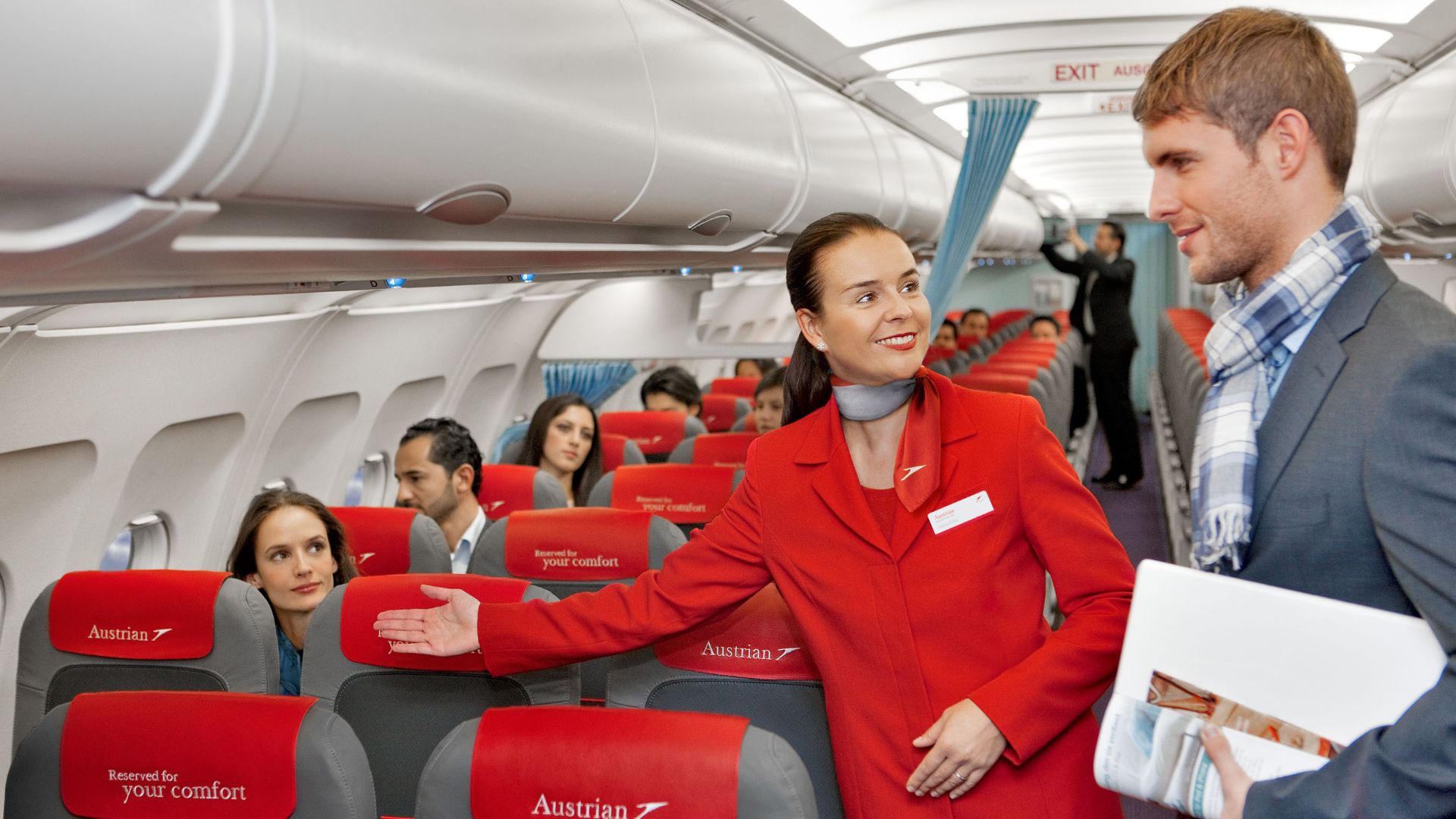 File:Austrian Airlines flight attendant and passenger.jpg