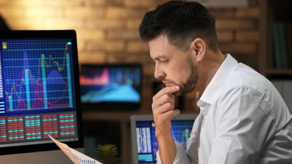 Young stock exchange trader working in office
